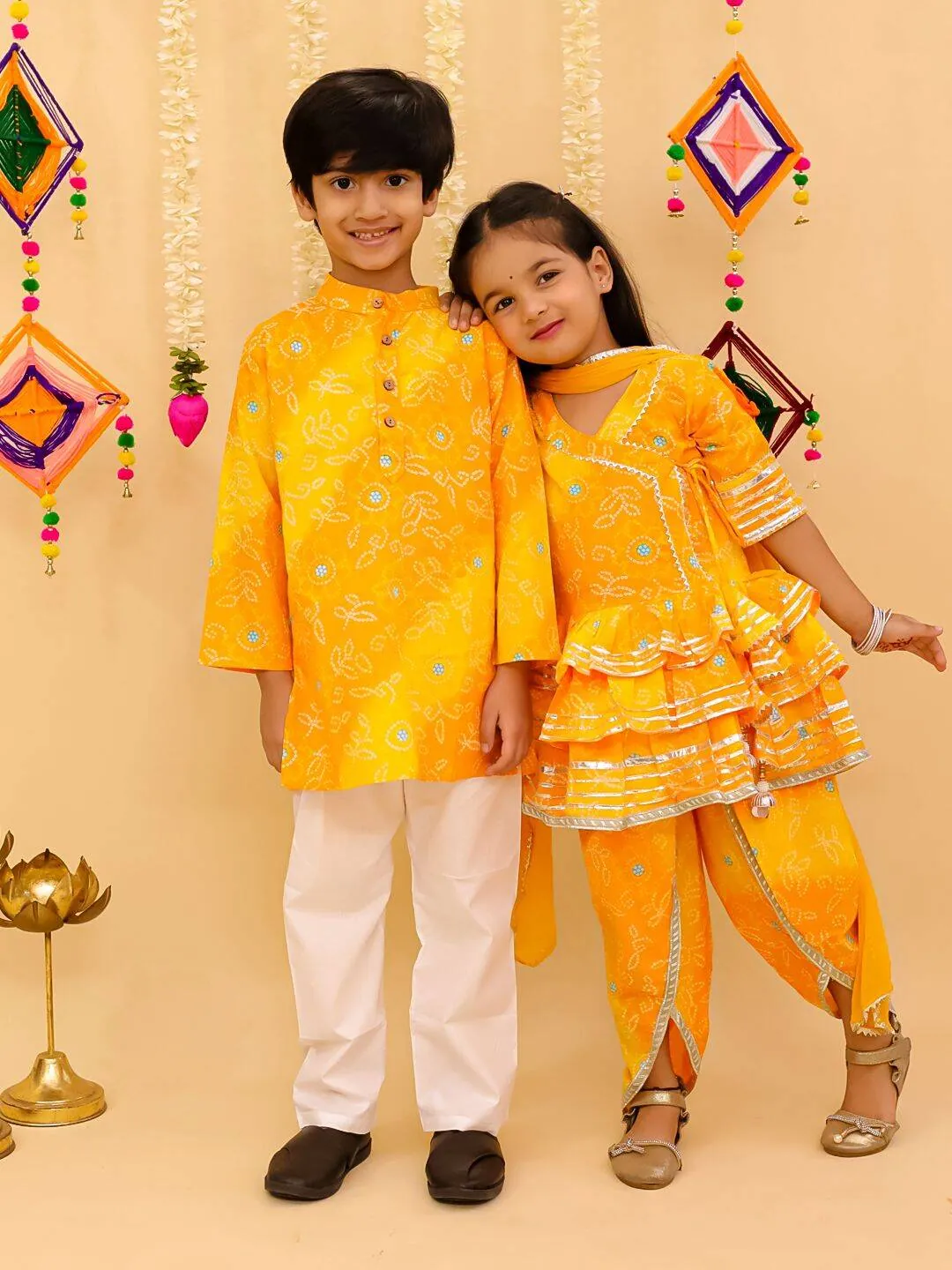 Siblings in saffron yellow Stay Desi festive outfits