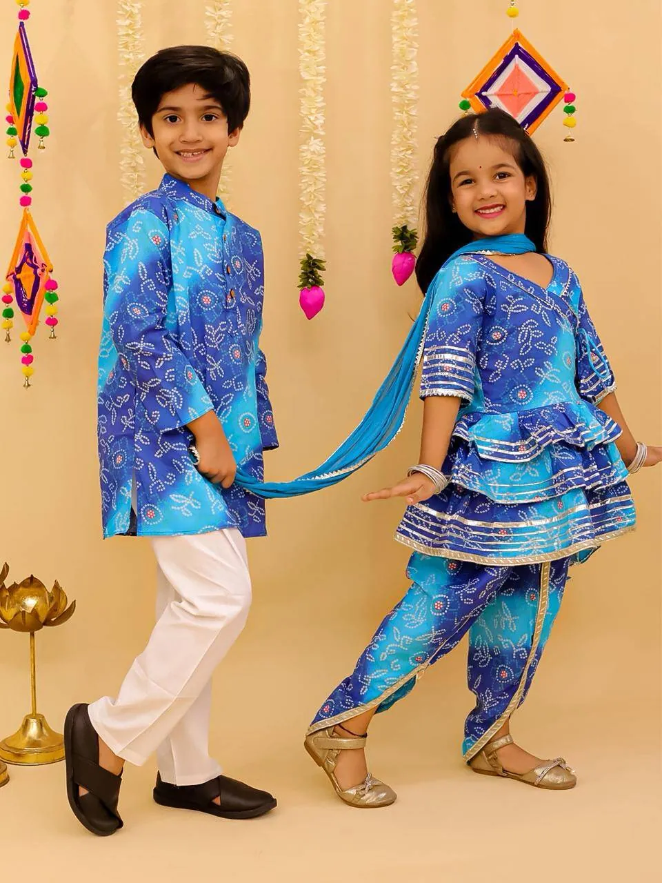 Brother and sister in matching blue bandhani kurta and dhoti sets